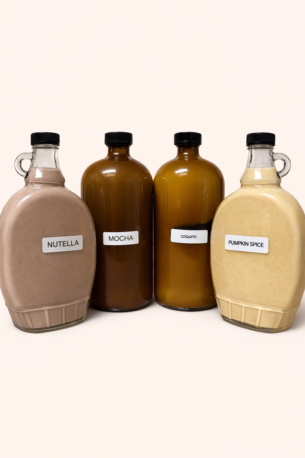 Four bottles of flavored coquito — Nutella, Mocha, Original, and Pumpkin Spice